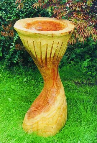 large carved wooden bird bath